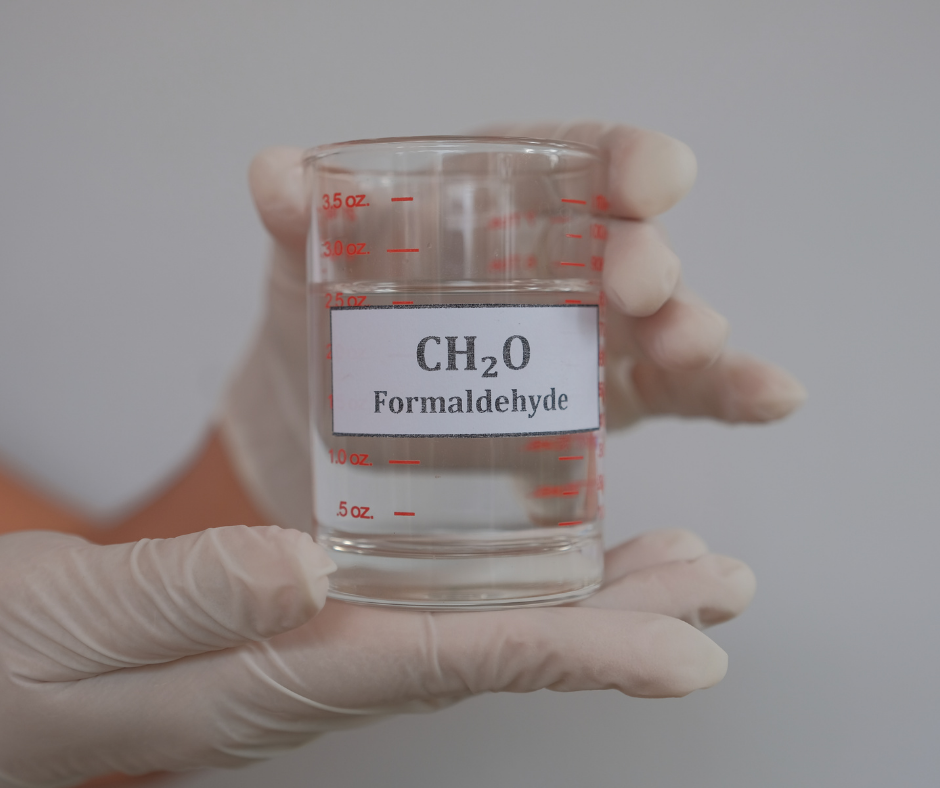 A measuring cup with a clear liquid in it, labeled CH20 Formaldehyde